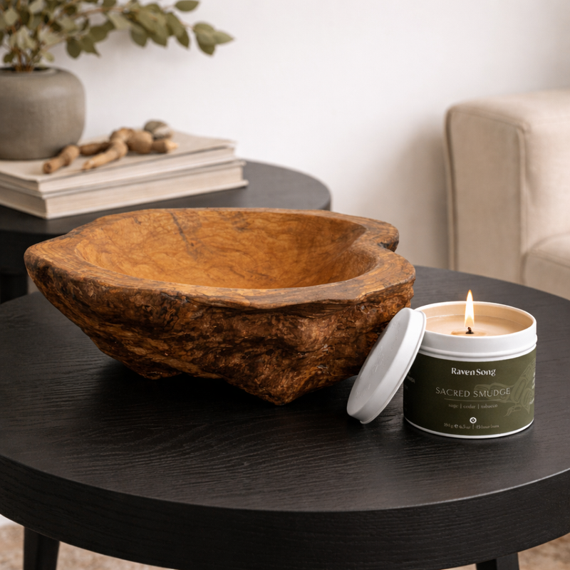 Custom cedar bowl on table next to ravensong candle with burning wick