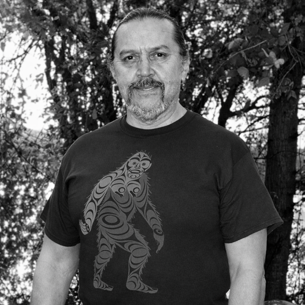 Black and white portrait of Francis Horne St with wearing an Indigenous designs Sasquatch t-shirt