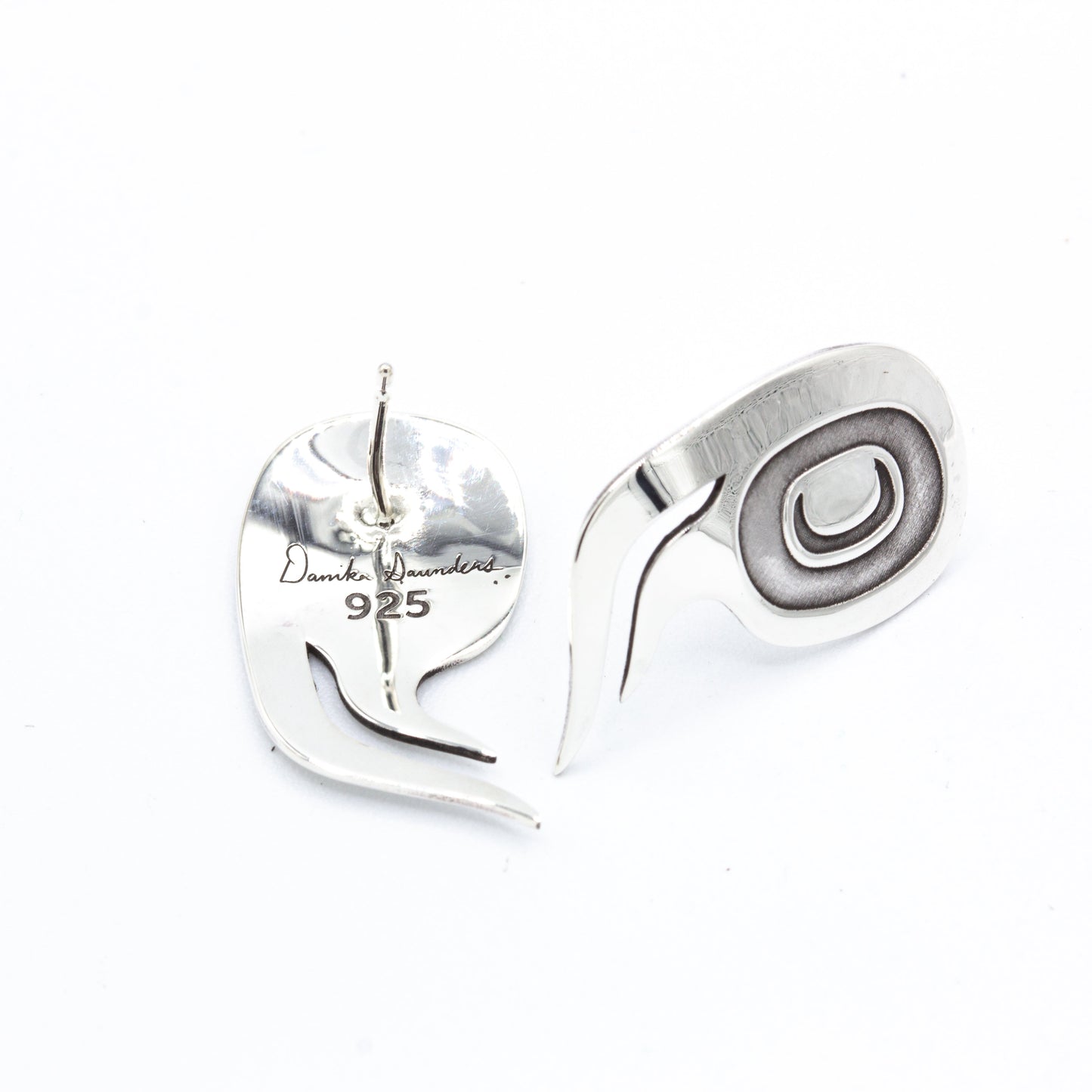Back of the sterling silver wolf studs stamped Danika Saunders and 925