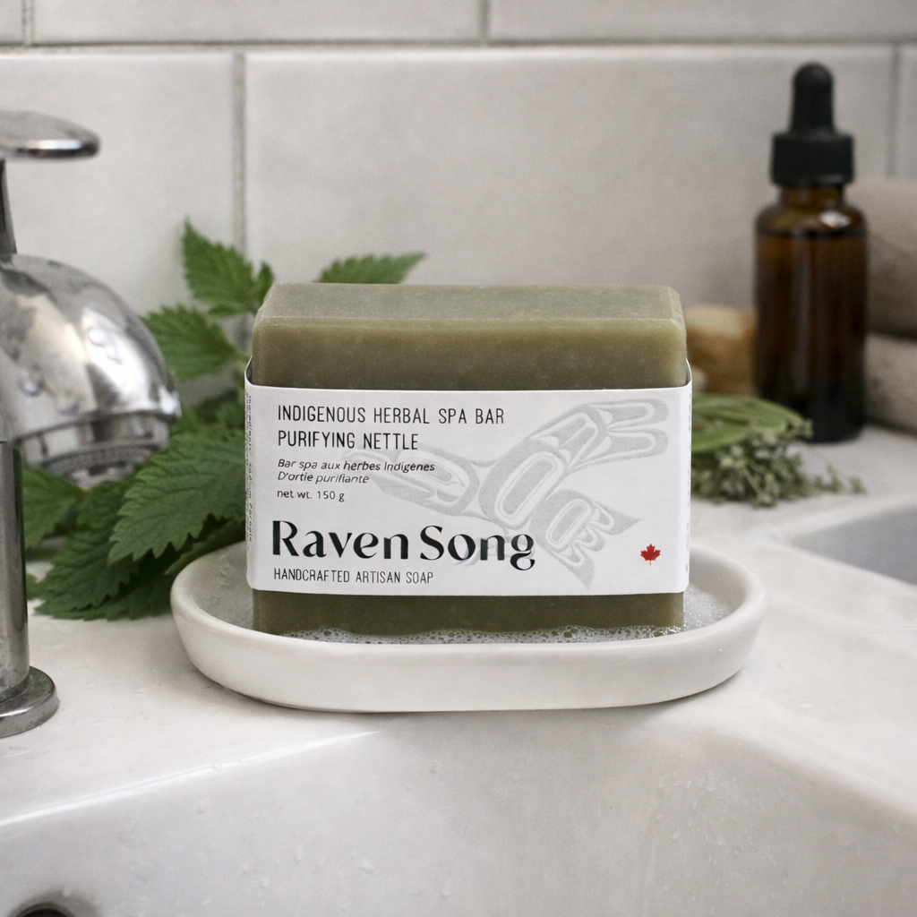 Bar of soap with 'Raven Song' branding on a white dish in a bathroom setting.
