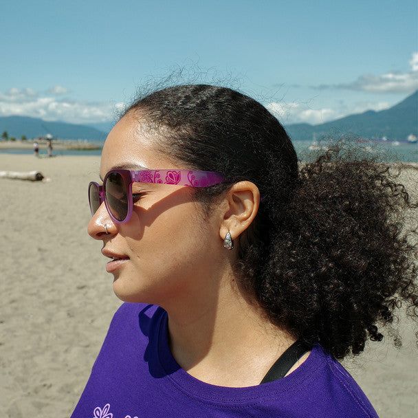 Woman on the beach wearing the purple glasses by Storm Angeconeb