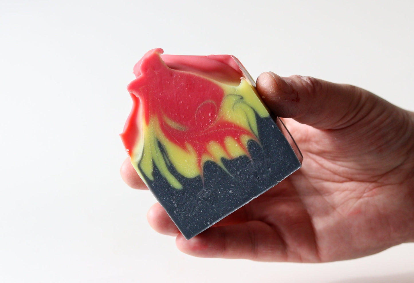 Sweetgrass Soap Deadly Aunty Soap bars showing the pink and yellow swirl over black charcoal.