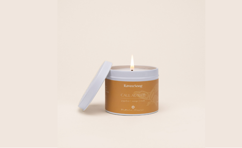 Ravensong candle Call Auntie orange exterior with burning wick