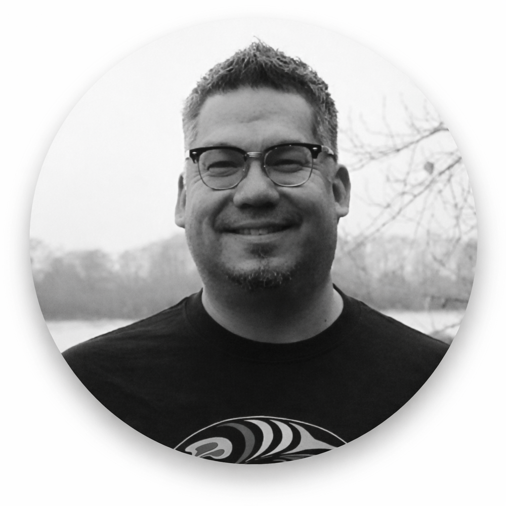 Black and white photo of Maynard Johnny Jr smiling outdoors