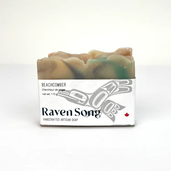 RavenSong Beachcomber artisan soap bar with a cream and teal top, wrapped in a white label with Northwest Coast formline raven art