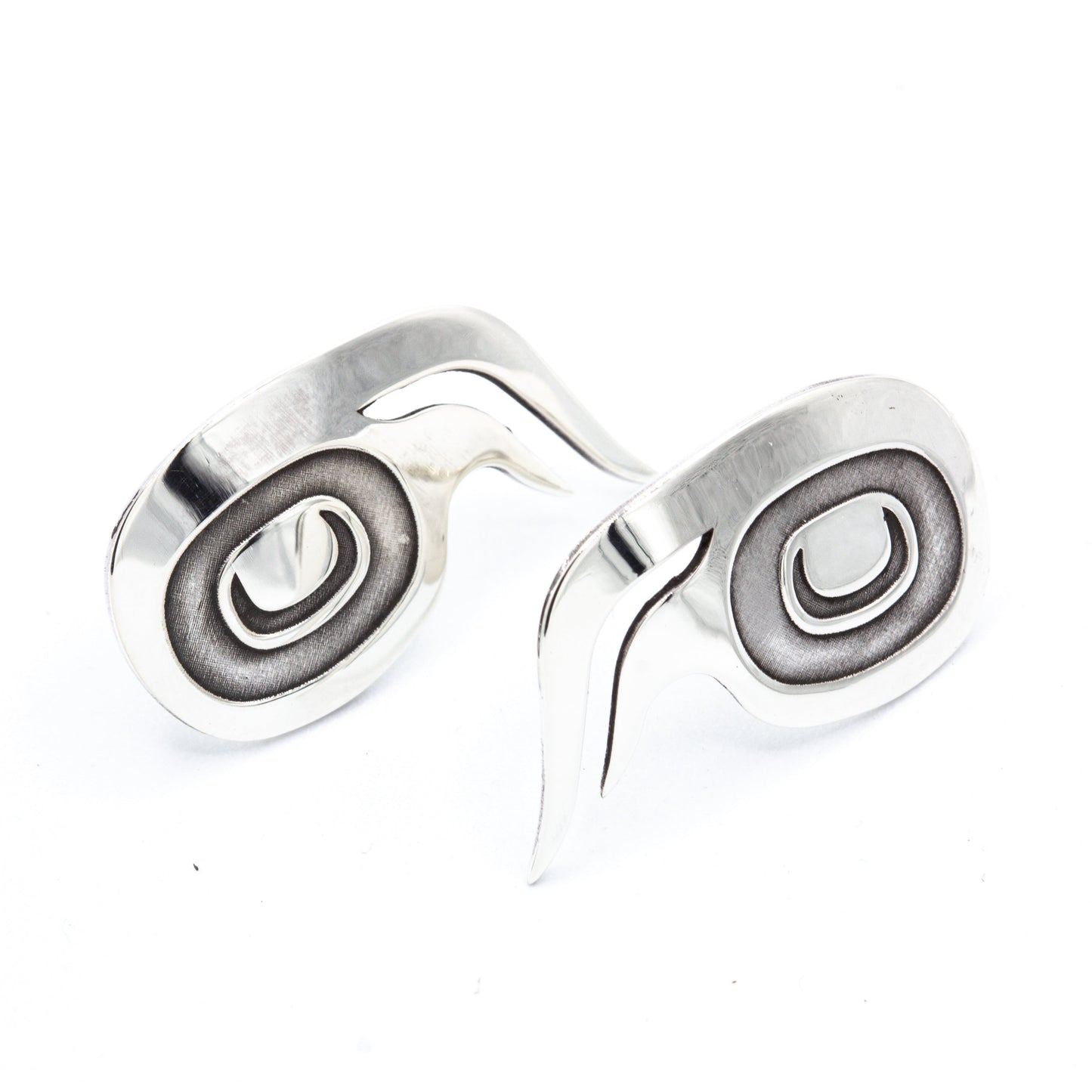 Sterling silver wolf stud earrings with oxidized spiral centres, designed by Danika Saunders