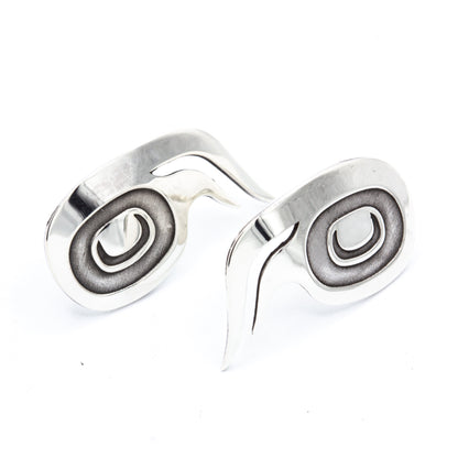 Sterling silver wolf stud earrings with oxidized spiral centres, designed by Danika Saunders