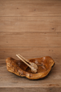 Wooden bowl and sticks on a wooden surface