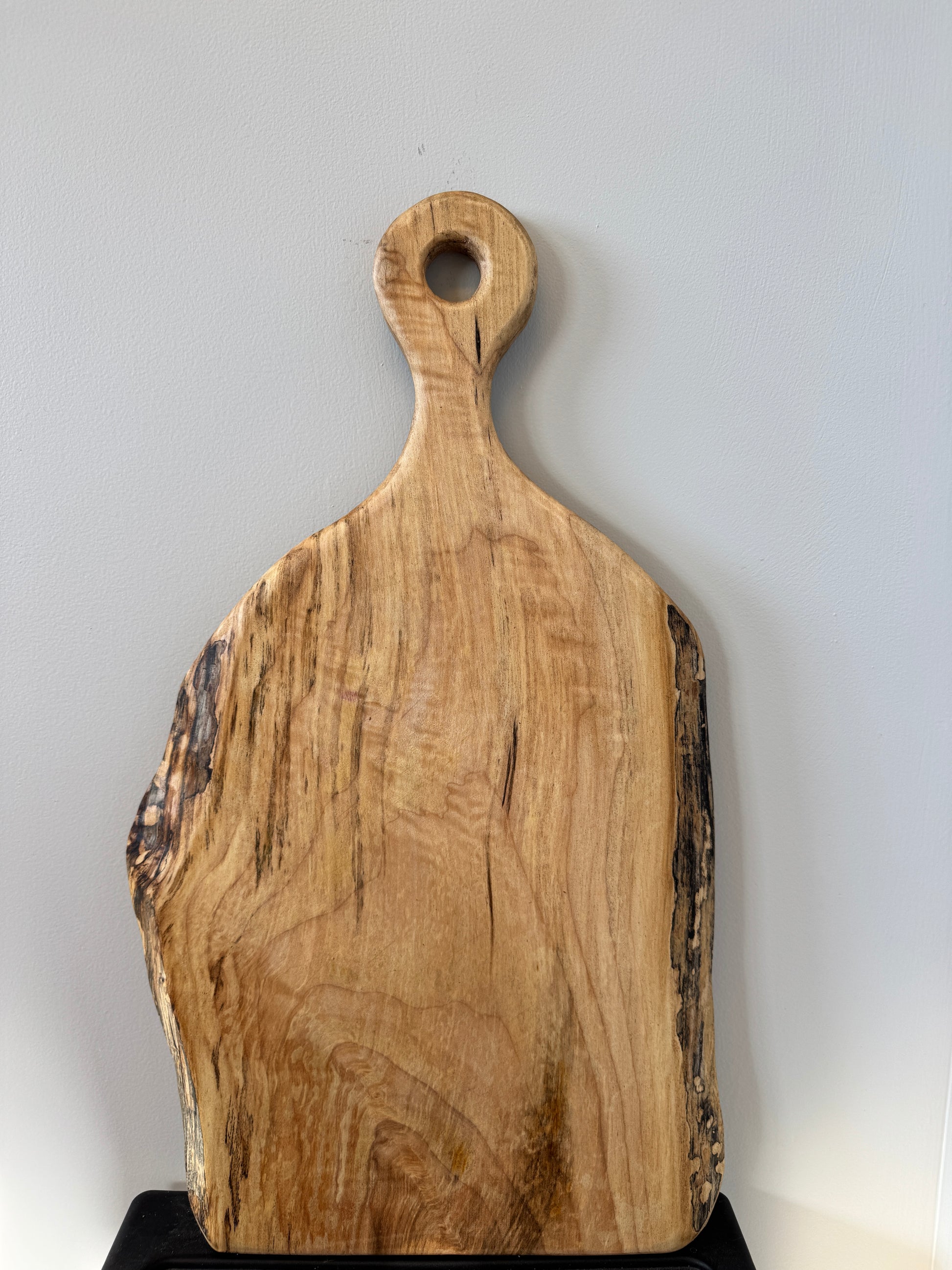 Wooden cutting board with a handle