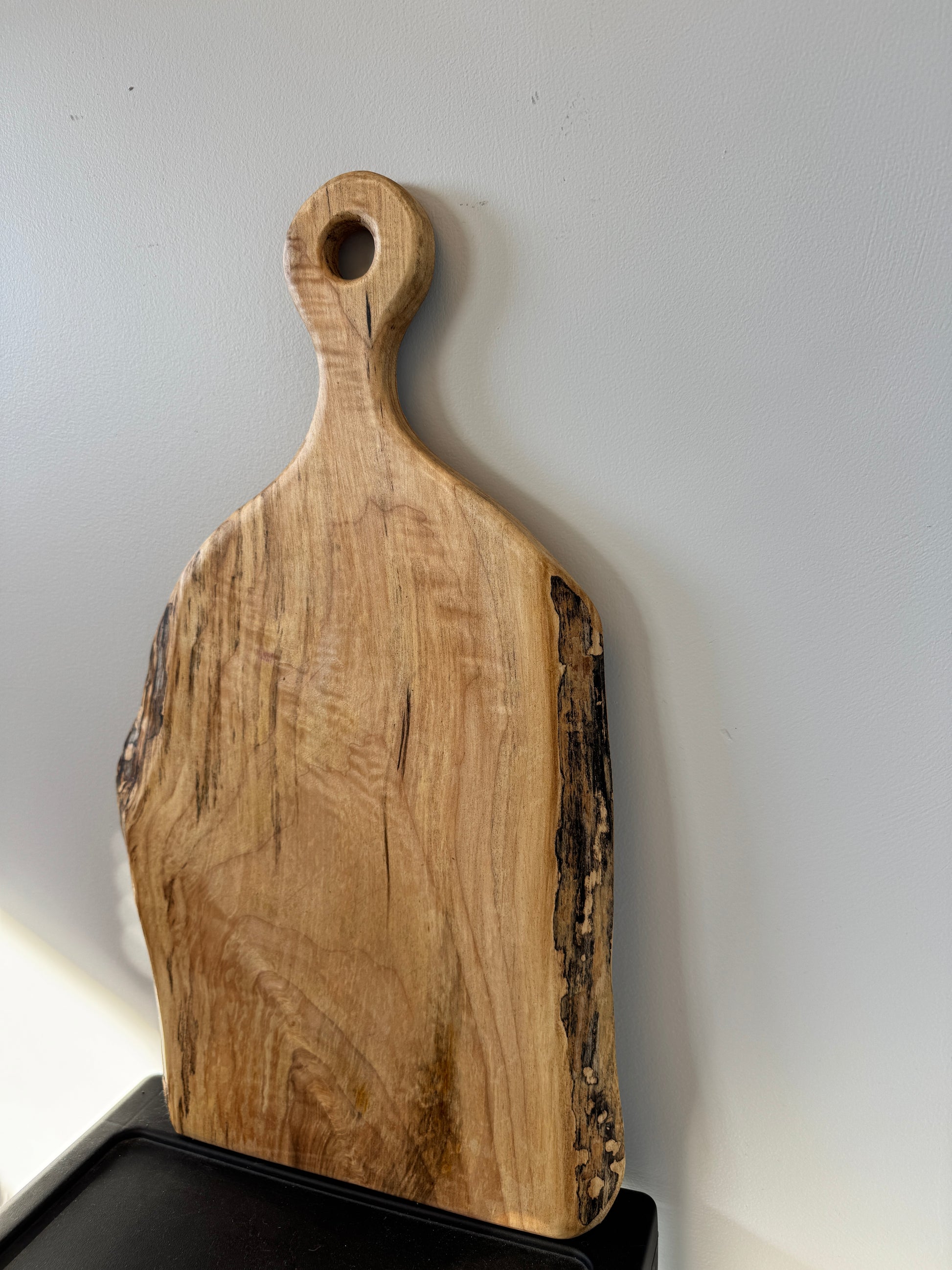 Wooden cutting board with a handle