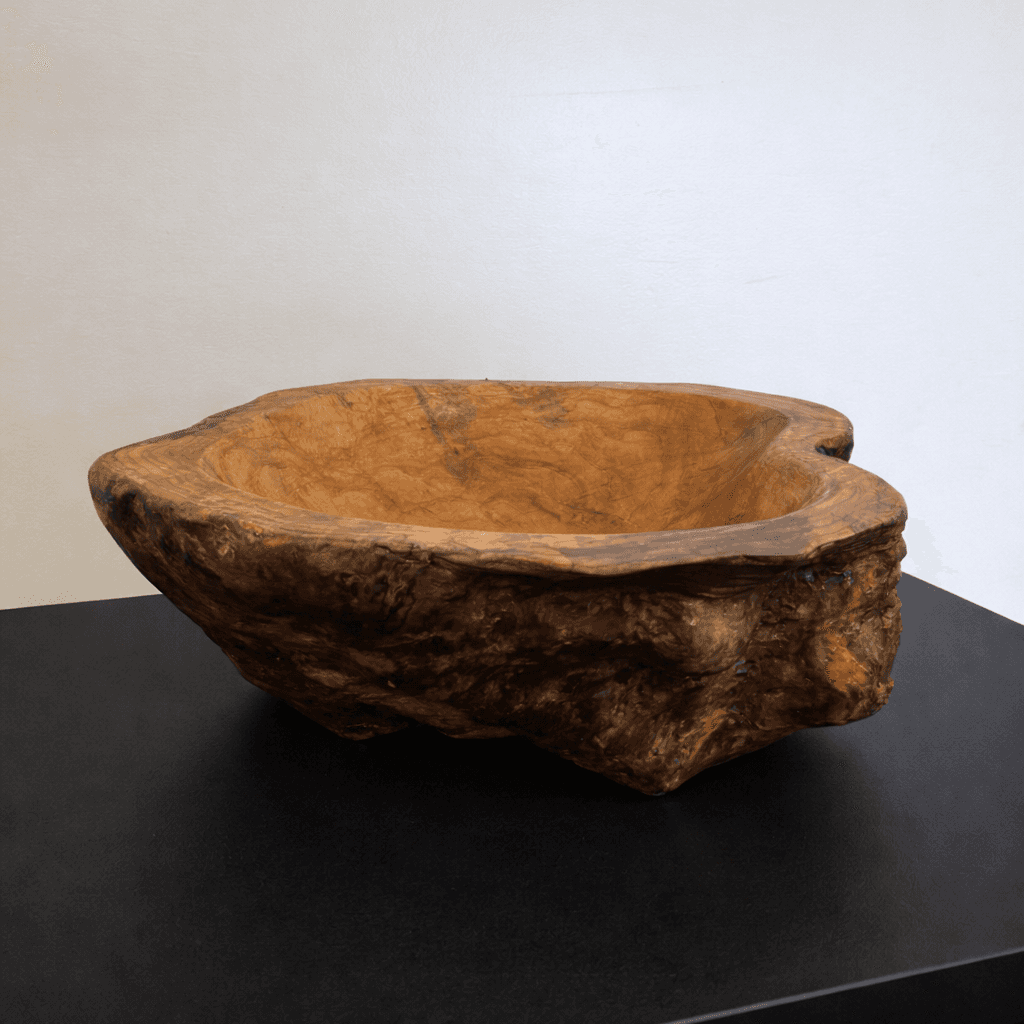 Wooden bowl with natural texture on a black surface