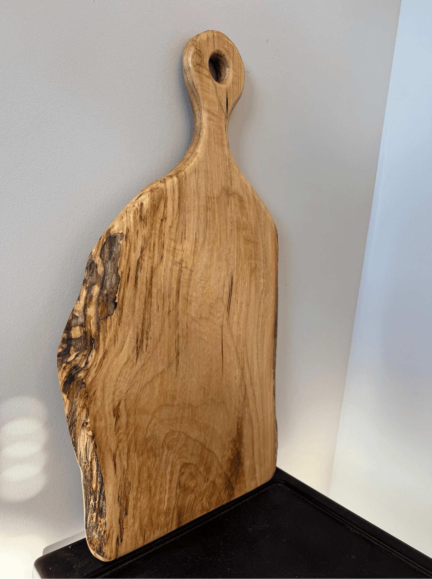 Wooden cutting board with a handle