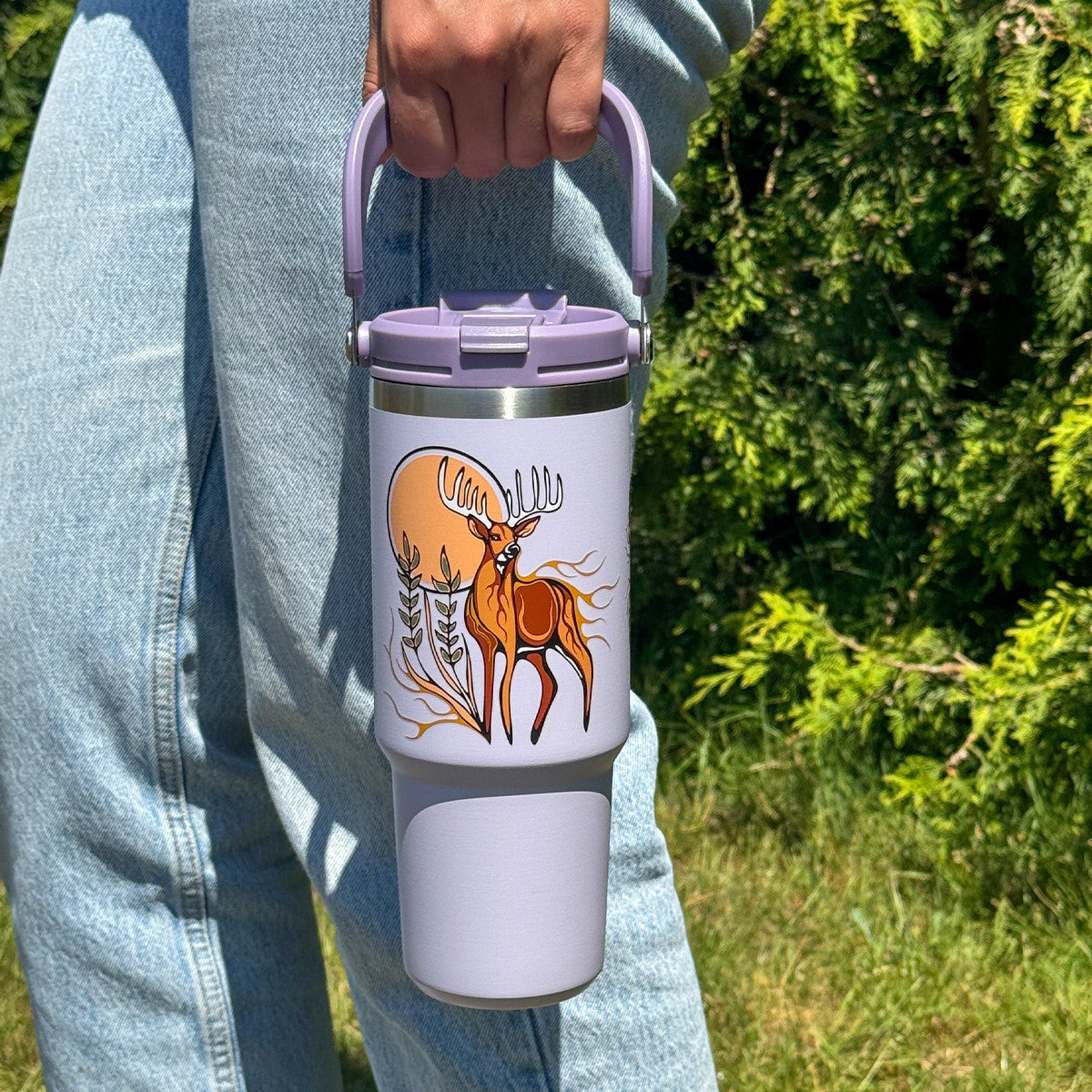 Deer Waawaashkeshi 30oz tumbler carried by the easy-carry handle outdoors