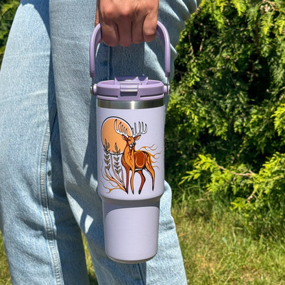 Deer Waawaashkeshi 30oz tumbler carried by the easy-carry handle outdoors