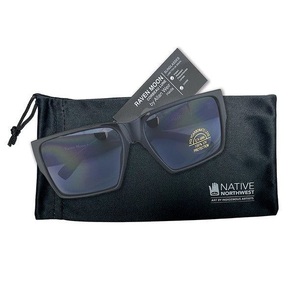 Raven Moon Sunglasses by Indigenous Artist Allan Weir displayed on top of sunglasses case