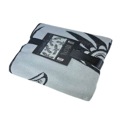 Soaring Eagle woven blanket folded with the packaging ribbon and card displayed in front of a white background