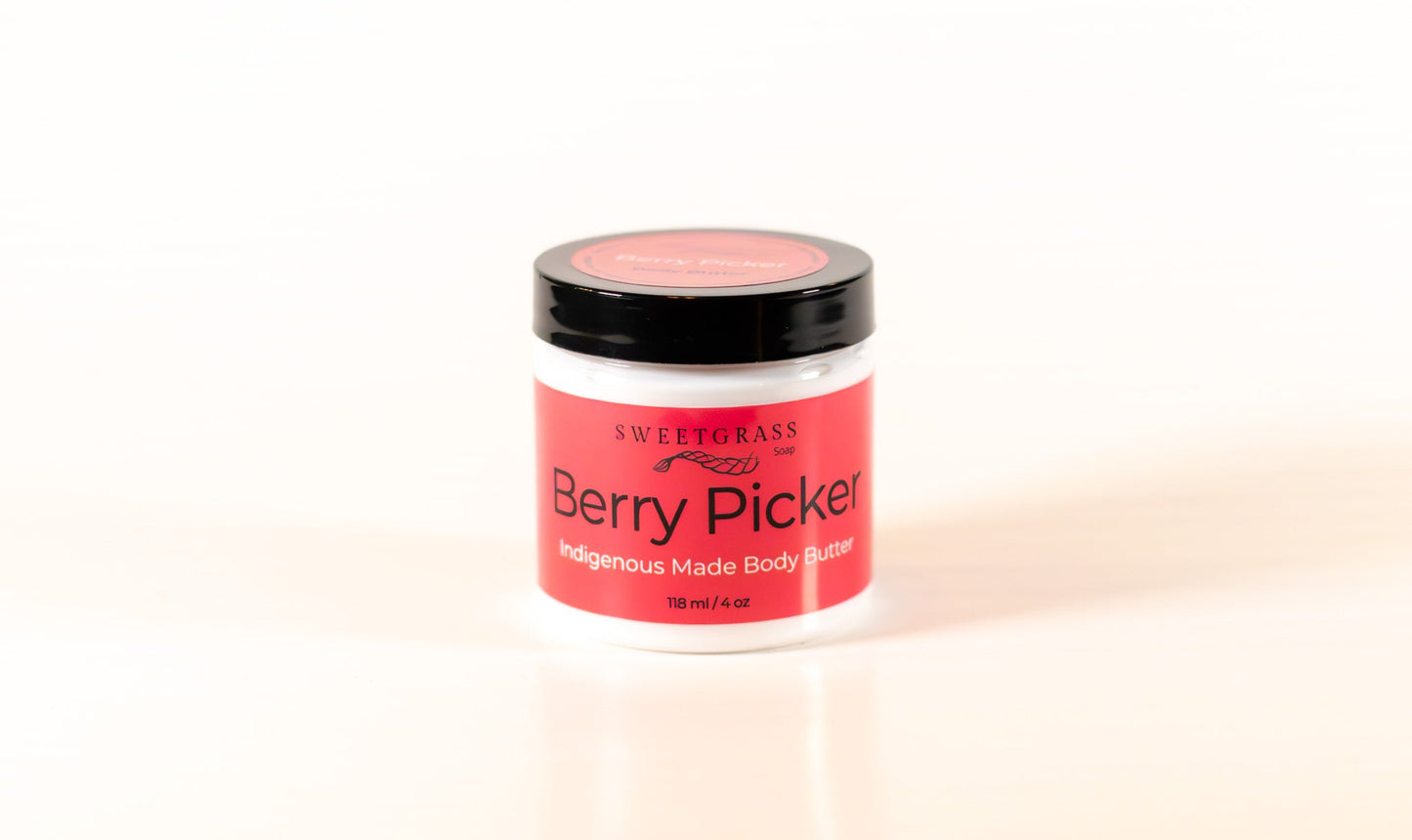 Sweetgrass Soap Berry Picker body butter in a clear jar with a black lid, 118 ml.