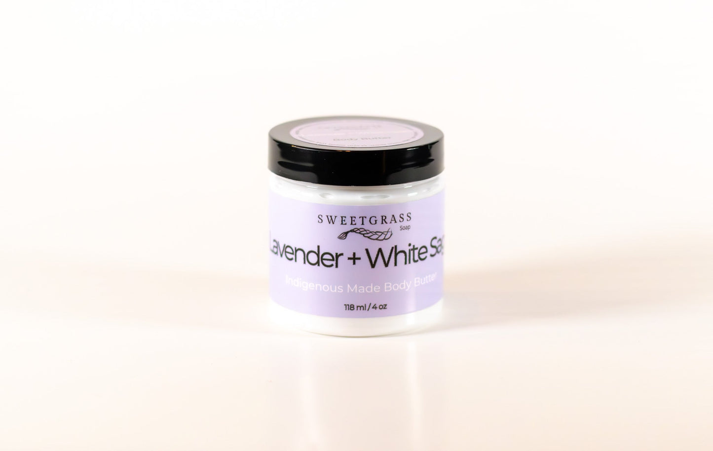 Sweetgrass Soap Lavender and White Sage body butter in a clear jar with a black lid, 118 ml.