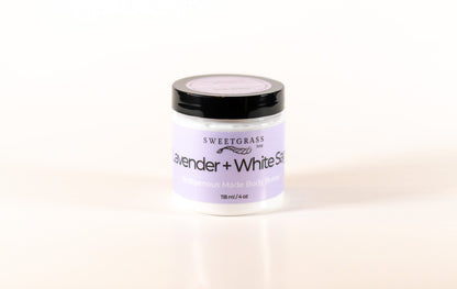 Sweetgrass Soap Lavender and White Sage body butter in a clear jar with a black lid, 118 ml.