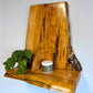 Wooden cedar live edge shelf with a plant and candle