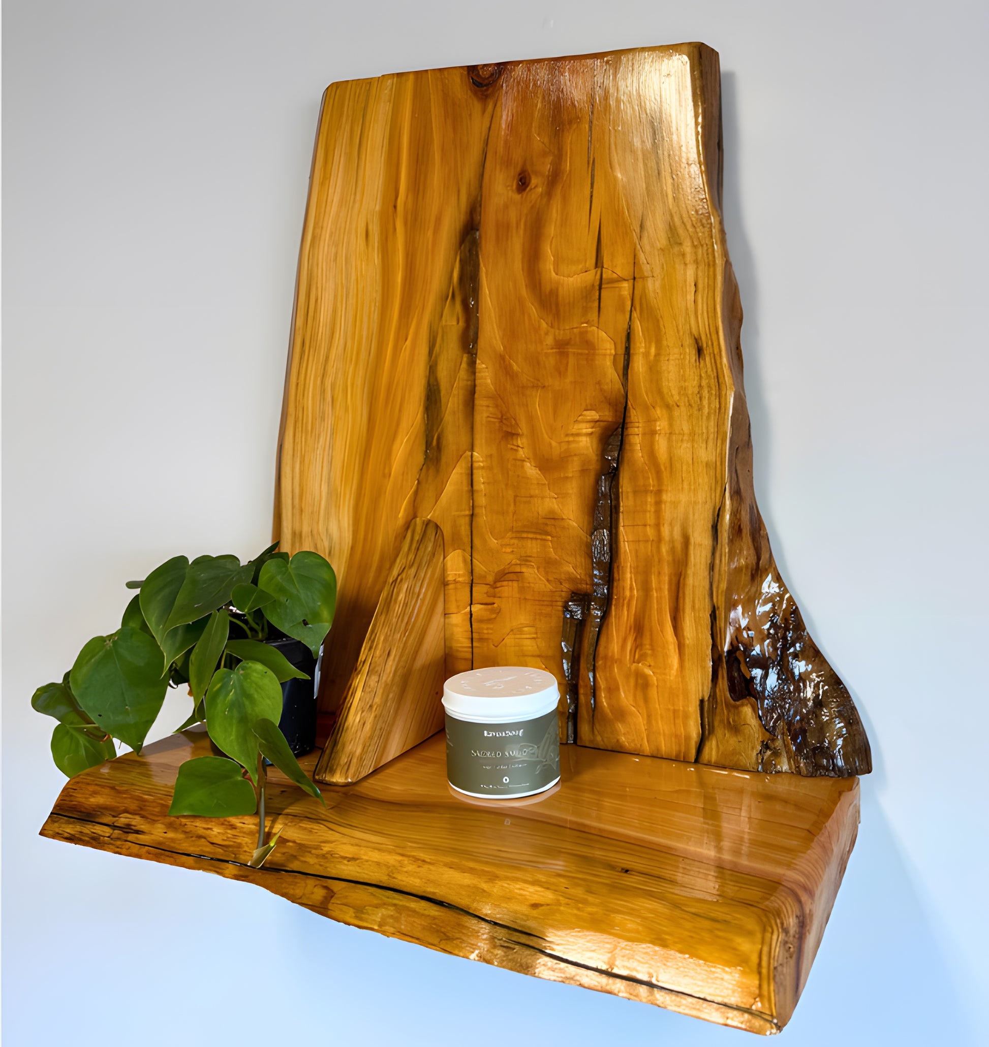 Wooden cedar live edge shelf with a plant and candle