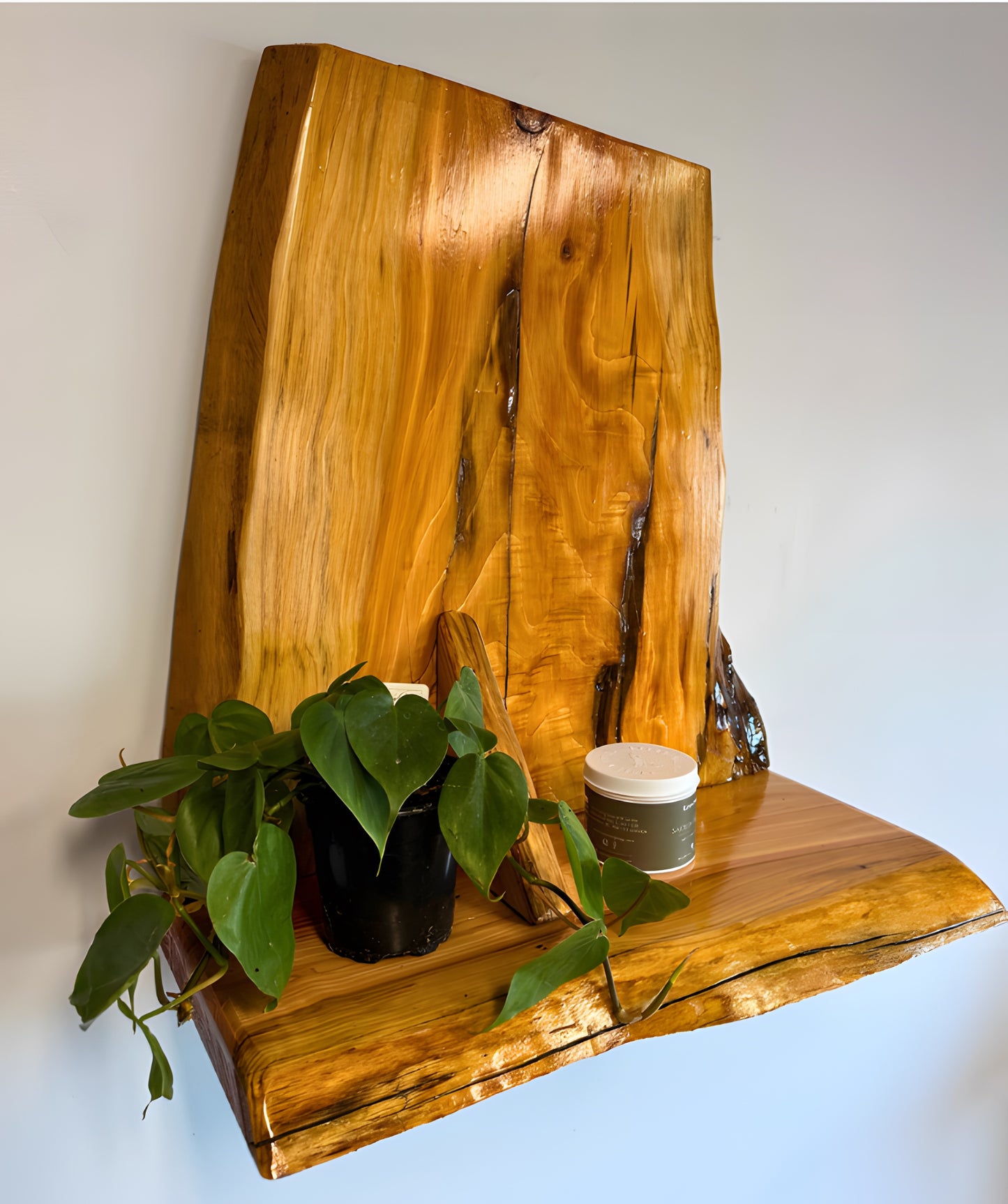 Wooden cedar live edge shelf with a plant and candle