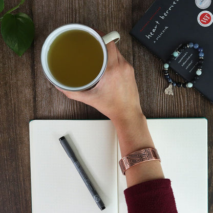 Copper Plated Bracelet - Eagle by Gordon White (Haida) — flat lay