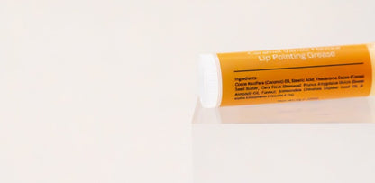 Bannock Grease lip balm tube on its side showing the ingredient panel.