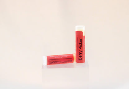 Sweetgrass Soap Berry Picker lip balm twist-up tube with a coral label, two shown.