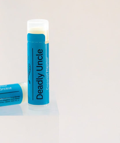 Deadly Uncle lip balm tube standing upright, blue label, coconut flavour.