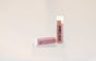 Sweetgrass Soap Sh*t Talker lip balm twist-up tube with a dusty pink watermelon label, two shown.