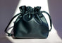 Sweetgrass Soap black vegan-leather drawstring toiletry bag with an embossed logo.