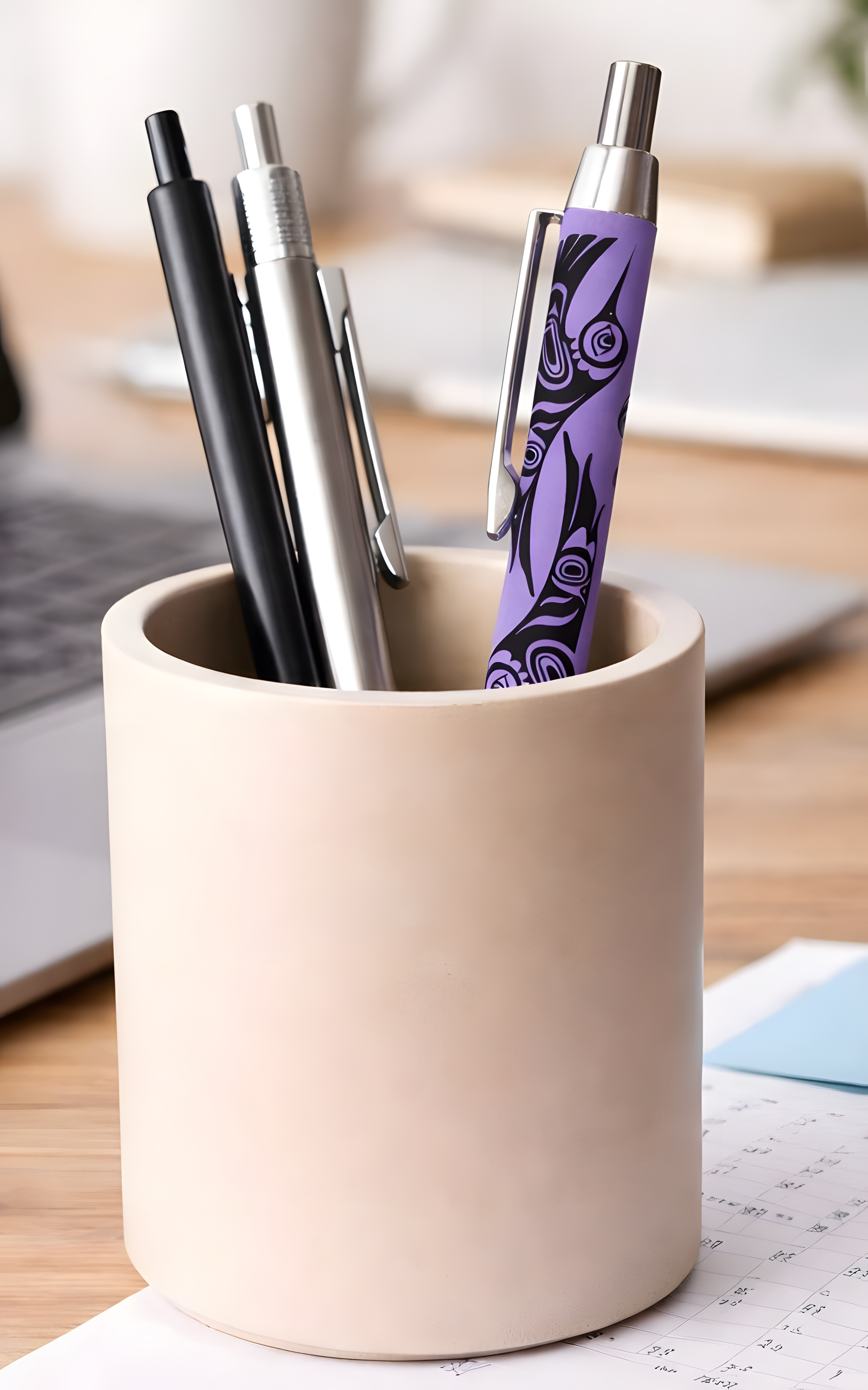 Purple pen with Indigenous eagle design in pen holder cup