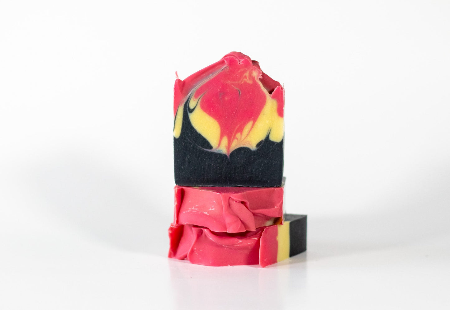 Sweetgrass Soap Deadly Aunty Soap, stacked bars with a pink, yellow and black charcoal swirl.