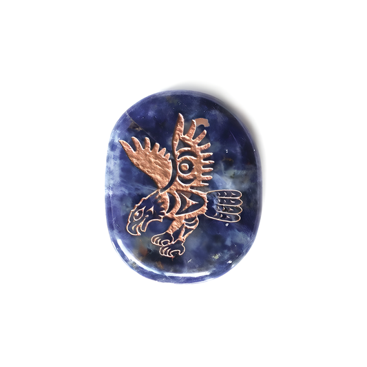 Round sodalite stone with Indigenous eagle design etched into it
