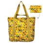 Yellow tote bag with hummingbird and floral pattern with it's feature foldable pouch displayed