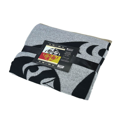 Diversity woven blanket folded with packaging ribbon and artist card on a white background