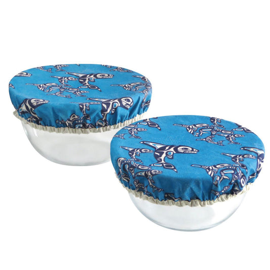 Two white bowls with blue covers featuring shark patterns 