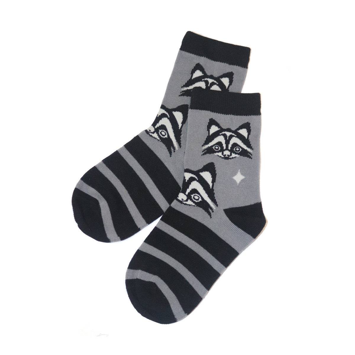 Two socks with raccoon designs