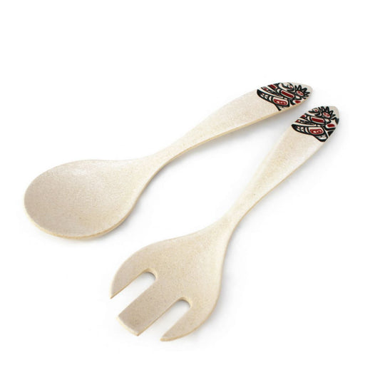 Wooden spoon and fork set with decorative handle on a white background